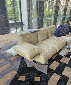Beige sofa seating cushion and armrest cushion before replacement at Menara Exchange 106 TRX by Mr Sofa