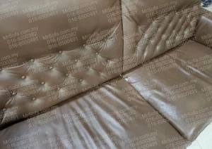 damaged-rozel-leather-sofa-seat-button-backrest-repair-by-mr-sofa Close up of damaged Rozel leather sofa seat and button backrest repaired by Mr Sofa