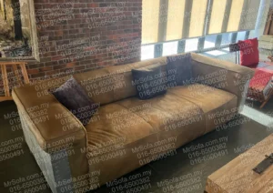Old Aircraft Riveted designer leather sofa with worn cushions before Mr Sofa restoration in KL